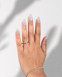 Aurora Pearl Almond press-on nails with radiant pearl finish and holographic shimmer by NEWRUSH