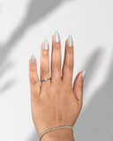 Aurora Pearl Almond press-on nails with radiant pearl finish and holographic shimmer by NEWRUSH
