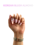 Korean Blush Almond press-on nails with soft blush pink tones and glossy milky white finish by NEWRUSH