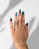 Teal Galaxy Almond luxury press-on nails with teal cat eye effect and shimmering finish by NEWRUSH