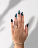 Teal Galaxy Almond luxury press-on nails with teal cat eye effect and shimmering finish by NEWRUSH