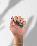 Teal Galaxy Almond luxury press-on nails with teal cat eye effect and shimmering finish by NEWRUSH
